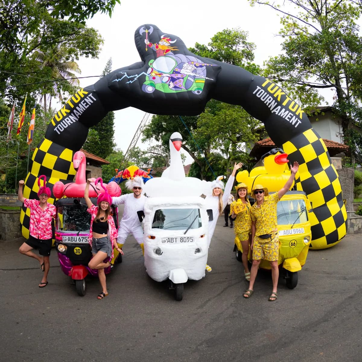 Three creatively decorated tuktuks at the starting arch